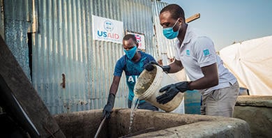 NORCAP expert Geophrey Oyugi and local operator Thomas Amum mixing human waste with water at the biogas plant in Malakal, South Sudan